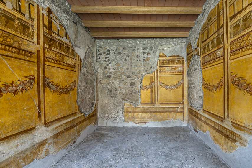 Murs ornés de fresques du troisième style pompéien avec guirlandes florales dans la Maison des Noces d’argent