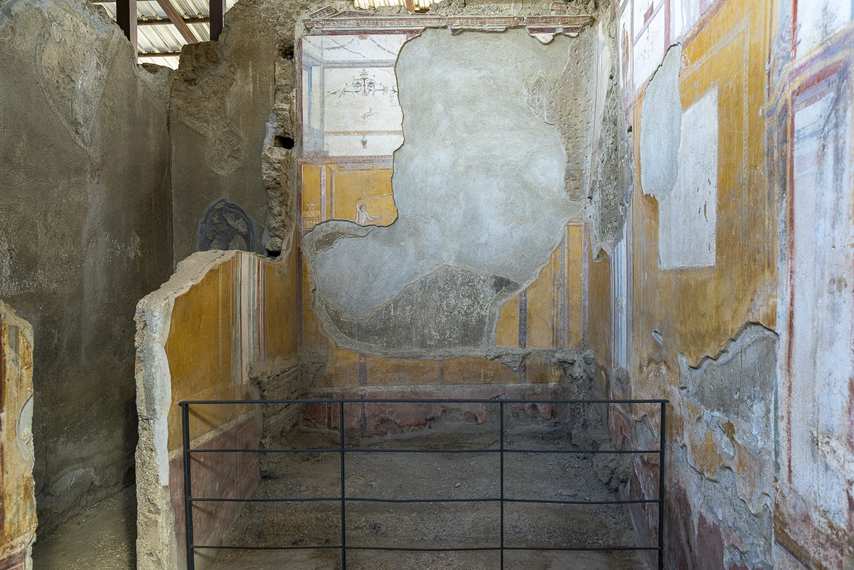 Damaged frescoes in a room of the House of Achilles Lararium in Pompeii