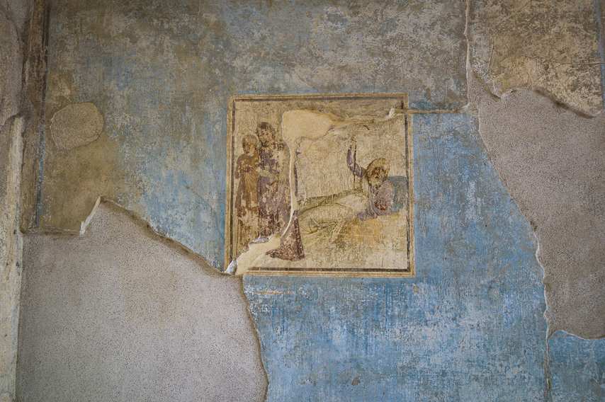 Ancient fresco on a blue background in the House of Casca Longus in Pompeii