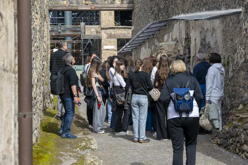 Group of students on a guided tour of the ruins of the Pompeii Archaeological Park