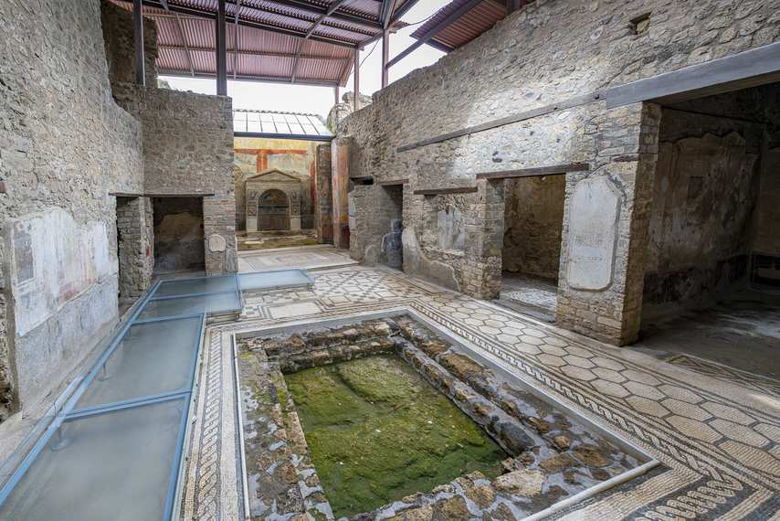 Central impluvium with mosaic floor and frescoed rooms in the House of the Wounded Bear in Pompeii