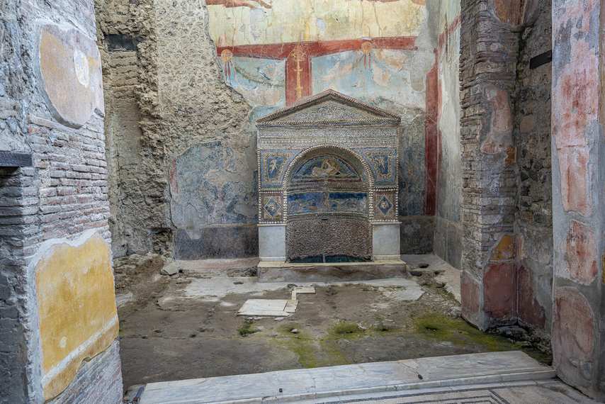 Mosaic decorated niche and colorful frescoes in the House of the Wounded Bear in Pompeii