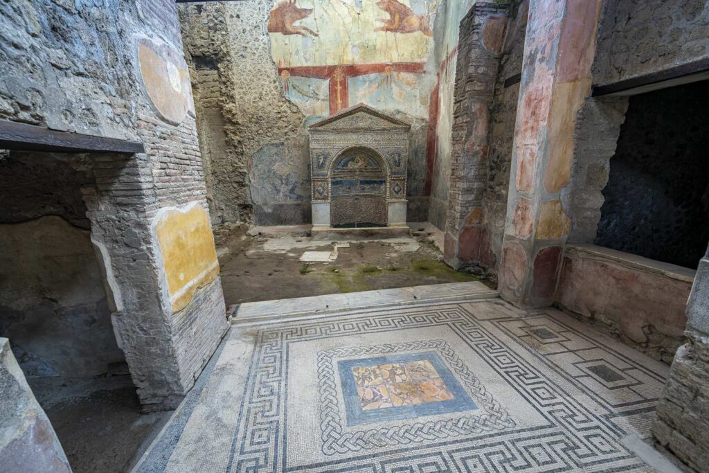 Decorative mosaic fountain with frescoes and mosaic floor in the House of the Wounded Bear in Pompeii