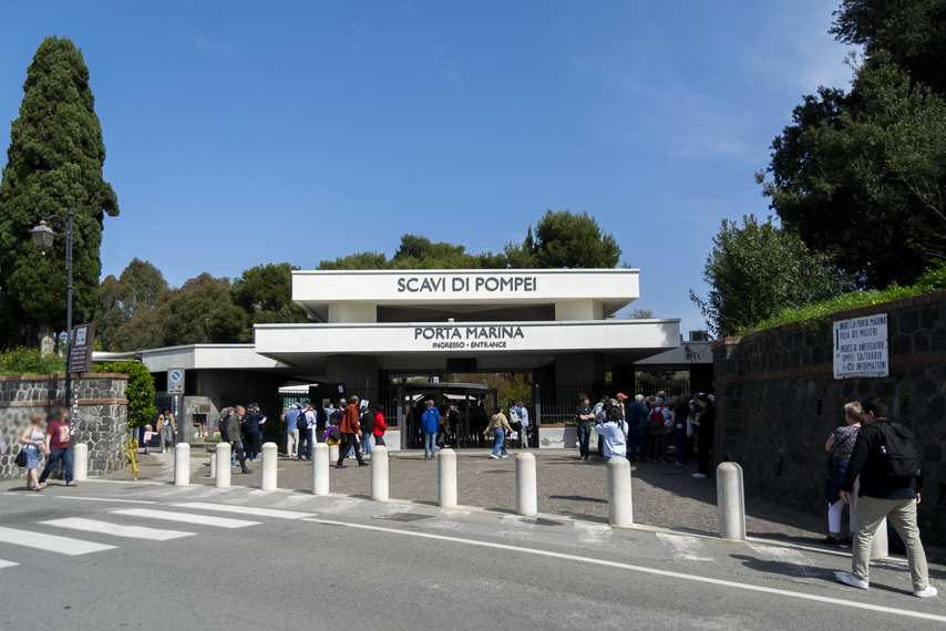 Main entrance to Pompeii Archaeological Park from Porta Marina with visitors waiting