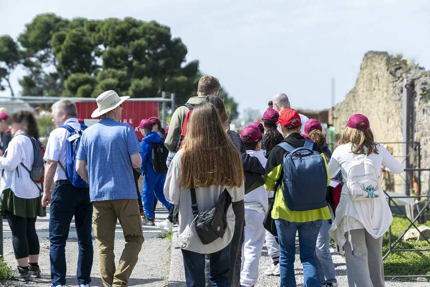 Group of students and tourists during a guided tour of the Pompeii excavations
