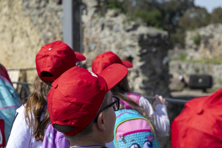 Children in red caps on school visit to the Pompeii Archaeological Park