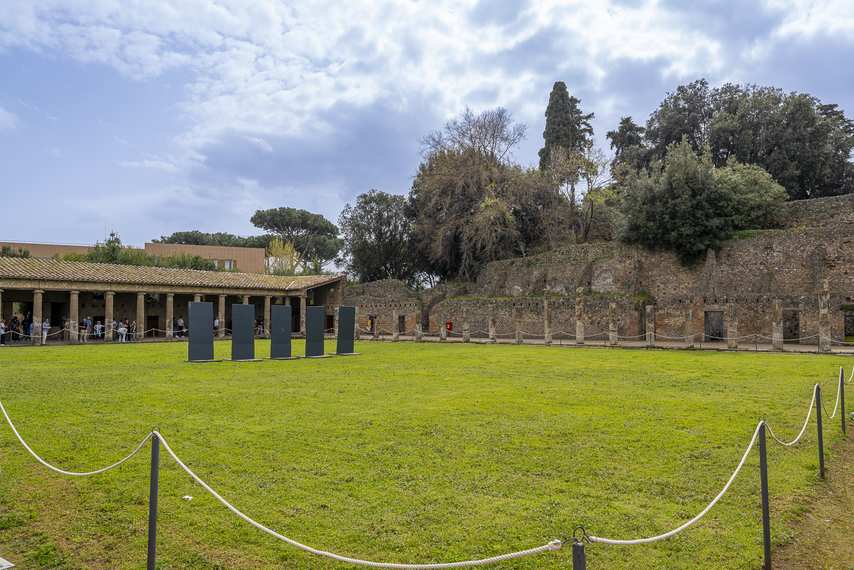 View of the Quadriporticus of the Theaters in Pompeii with porticoes and green area