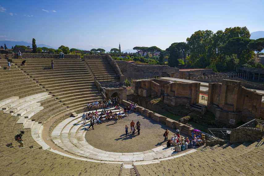 Top view of Pompeii's Large Theatre with tourists taking center stage