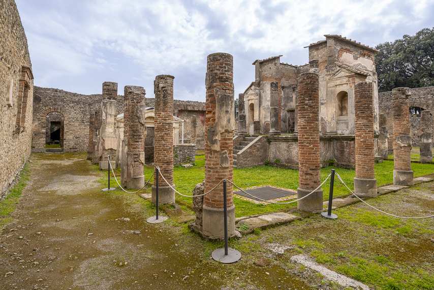 View of the sacred area of the Temple of Isis in Pompeii with brick columns and central structure
