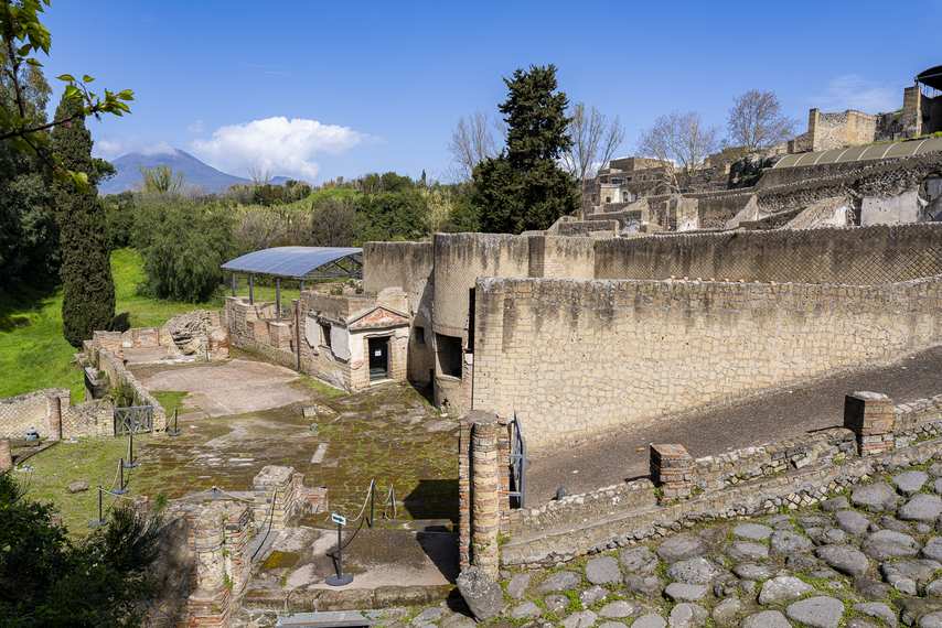 Exterior view of Pompeii's Suburban Baths with Vesuvius in the background